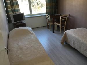 Postel nebo postele na pokoji v ubytování Leo Hotelli