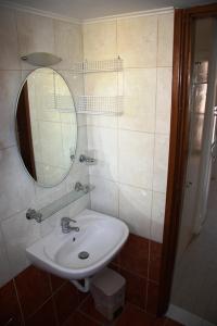 a bathroom with a sink and a mirror at Dimitris Apartments in Bali