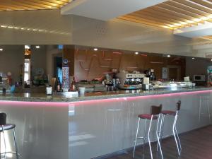 a bar in a restaurant with stools at Hotel Buenos Aires in Villafría de Burgos