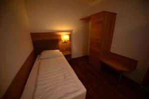 Ένα ή περισσότερα κρεβάτια σε δωμάτιο στο Hotel Linde Stuttgart - Self Check-In