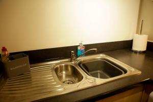 a kitchen sink with a soap bottle on it at Newly refurbished 1 bed first floor apartment with wifi in Cosham