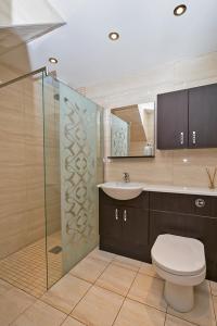 a bathroom with a toilet and a sink and a shower at 37A Commerce Street in Lossiemouth