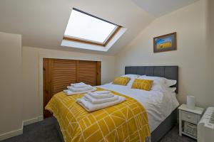 a bedroom with a bed with towels on it at 37A Commerce Street in Lossiemouth