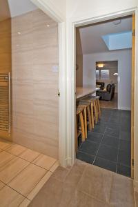a room with a kitchen with a counter and some chairs at 37A Commerce Street in Lossiemouth +8 photos