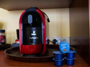 a red blender sitting on a counter with blue cups at Apartament Stare Miasto 1 in Elblag
