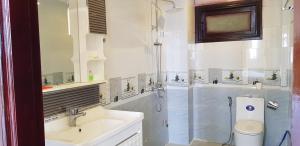 a bathroom with a shower and a sink and a toilet at Hai Dang Hotel in Ho Chi Minh City