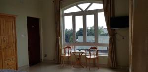a room with a table and two chairs and a window at Hai Dang Hotel in Ho Chi Minh City +61 photos