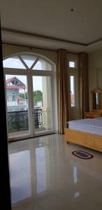 a bedroom with a bed and a large window at Hai Dang Hotel in Ho Chi Minh City
