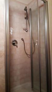 a shower in a bathroom with a glass shower stall at La Casa nel Borgo in Torre Orsina