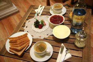 einen Tisch mit Essen, Tassen Kaffee und Toast in der Unterkunft Nuevo Suizo in Sevilla