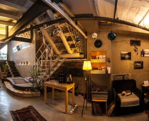 a living room with a staircase and a couch and a table at Peradays in Istanbul