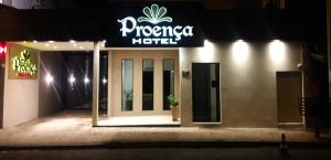 a hotel with a sign on the front of it at night at Proença Hotel in Barretos