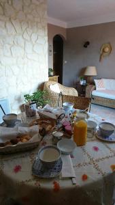 a table with food on it with a table cloth at B&B La Boissière Et Le Vialat in Montagnac