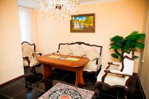 a living room with a table and two chairs at Hotel Nurlytau in Borovoye
