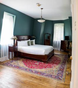 a bedroom with a bed and a rug at Queen Anne Inn in Annapolis Royal