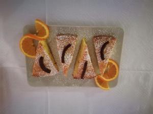 a piece of orange cake with the word mess at B&B La Magnolia in Sulmona