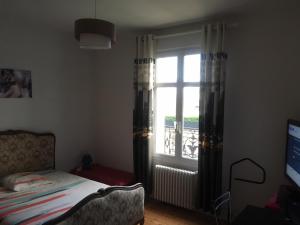 Ένα ή περισσότερα κρεβάτια σε δωμάτιο στο Chambre meublée