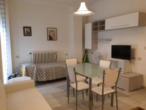 a living room with a table and chairs in a room at New Prophet Appartamenti in Cattolica