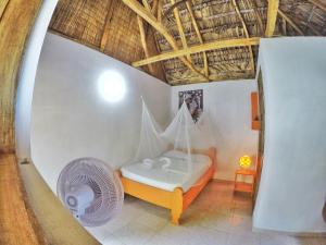 Habitación con cama con red en coin perdu guest house, en Jacmel