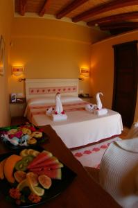 a bedroom with a bed with two swans sitting on it at Santa Maria Resort in Orosei