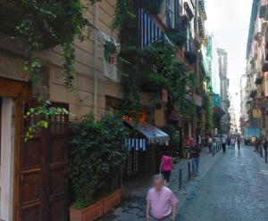 a group of people walking down a city street at Residenza Maranto in Naples