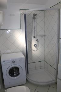 a bathroom with a washing machine and a shower at Le Case dei Pescatori - Coccinella Rossa in Ponza +32 photos