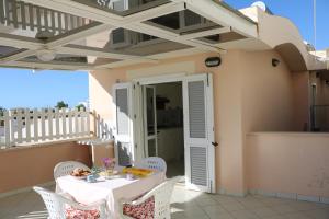 a table and chairs on the balcony of a house at Le Case dei Pescatori - Coccinella Rossa in Ponza
