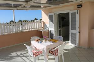 a white table and chairs on a patio at Le Case dei Pescatori - Coccinella Rossa in Ponza