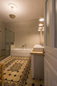 a bathroom with a tub and a sink at Artdecoathens in Athens +36 photos