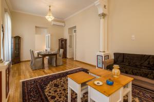 a living room with a couch and a table at Artdecoathens in Athens