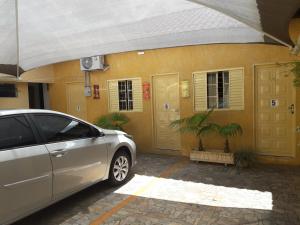 a car parked in front of a house at Hotel Nobre in Tupã