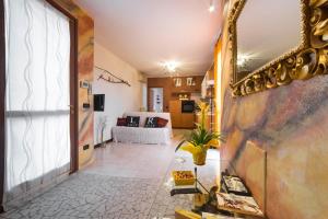 a hallway with a mirror and a living room at MB Place Abano Terme in Abano Terme