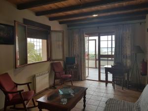 a living room with a couch and a table at Villa SABENA in Cazorla