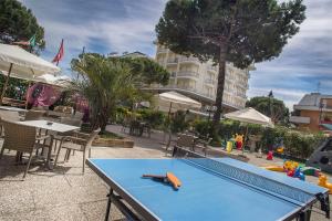 a ping pong table with a ping paddle on top of it at Hotel Marcus in Bellaria-Igea Marina