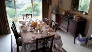 a table in a kitchen with a table cloth on it at Waterview Gardens B&B in Margate