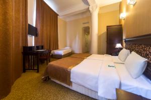 Voodi või voodid majutusasutuse Legends Tskaltubo Spa Resort toas