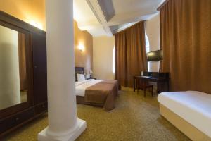 Voodi või voodid majutusasutuse Legends Tskaltubo Spa Resort toas