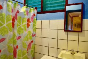 La salle de bains est pourvue de toilettes, d'un lavabo et d'un miroir. dans l'établissement Hospedaje Central, à Moyogalpa