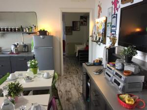 a kitchen with a table and a refrigerator at B&B La Terrazza Sul Mare Taormina in Taormina