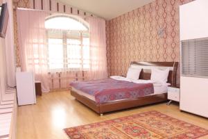 a bedroom with a bed and a dresser at Ivy Boutique Hotel in Yerevan
