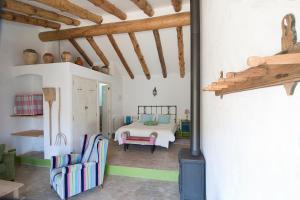 a bedroom with a bed and a fireplace at Mas Ardevol PT106 in Porrera