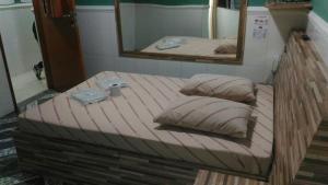 Cama o camas de una habitación en Hotel Flor do Gomide