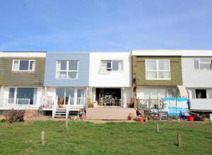 a large house with a porch and a yard at Pebbles Beach House By Air Premier in Seaford