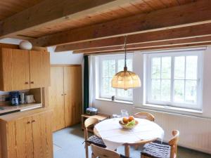 a kitchen with a table with a bowl of fruit on it at Ferienwohnung Bi Elschen in Nebel +23 photos