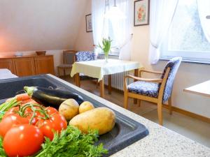 a kitchen with a tray of vegetables on a counter at Haus *Üüs Aran* Wohnung Nr. 7 in Nebel