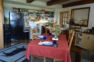 a kitchen with a table with a red table cloth at Mount Harmony Farm Guest House in Sheffield