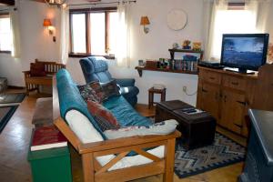 a living room with a couch and a tv at Mount Harmony Farm Guest House in Sheffield
