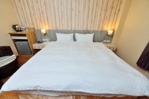 Posteľ alebo postele v izbe v ubytovaní Fu Yu Spring House