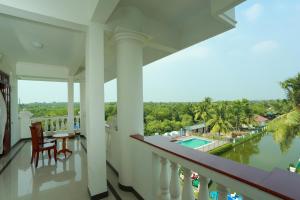 a balcony of a house with a view of the water at PJ Princess Regency in Cochin