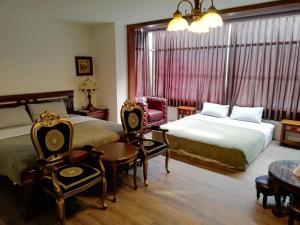 Postel nebo postele na pokoji v ubytování Tata House B&B